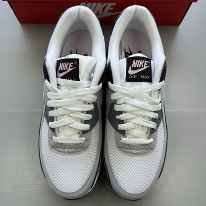 Nike Air Max 90 white trainers with pink foam accents and grey detailing.