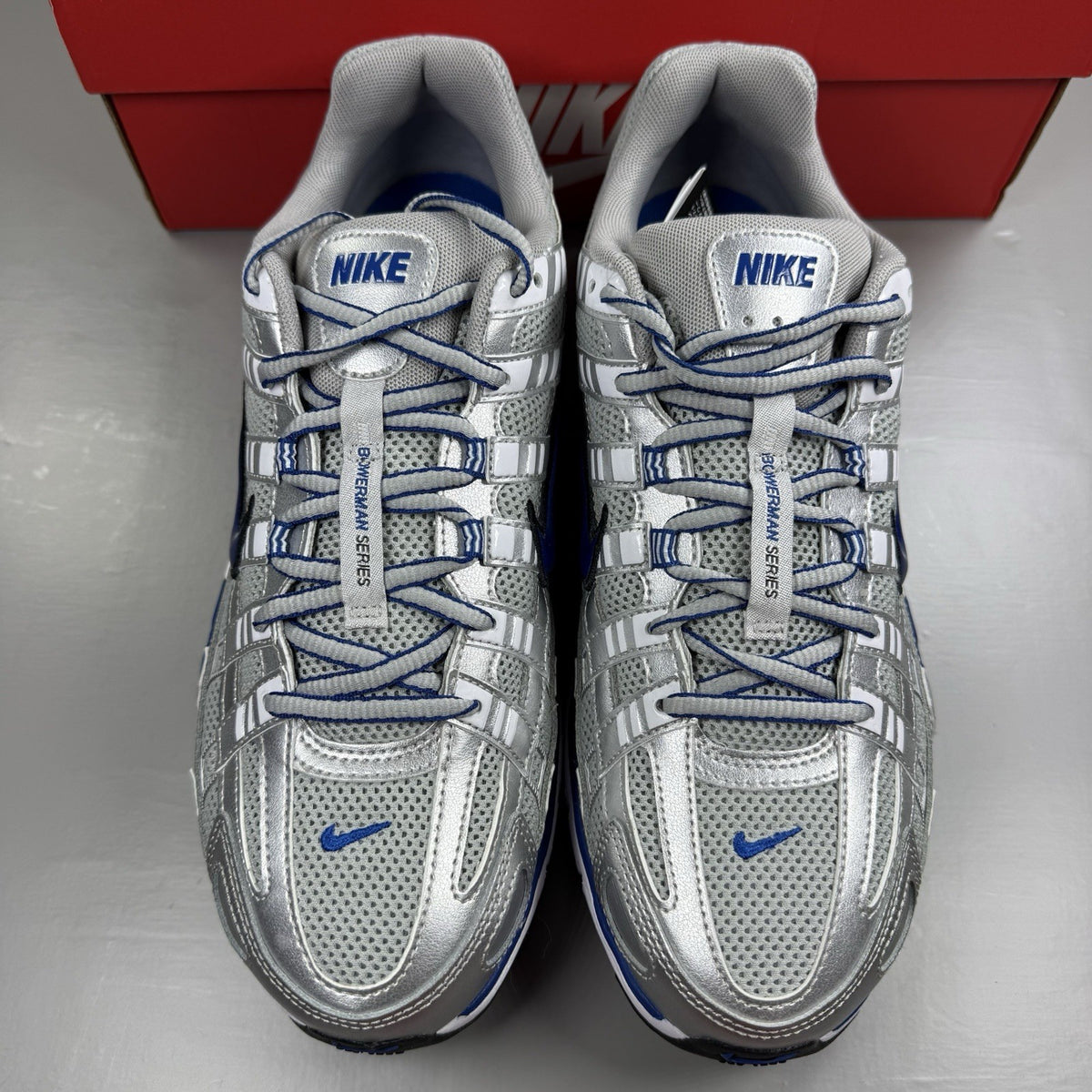 Nike P-6000 trainers white with laser blue and silver accents, mesh material, logo detail.