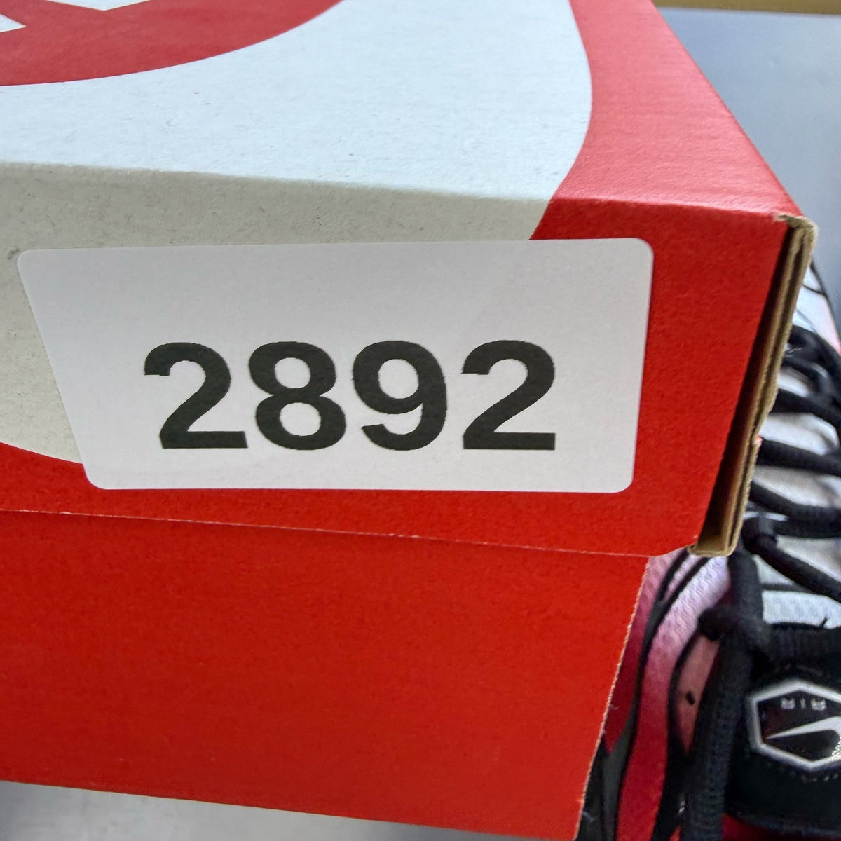 Nike Air Max Plus TN red with pure platinum accents and iconic logo detail.
