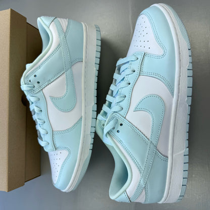 Nike Dunk Low trainers glacier blue and white with signature swoosh logo.