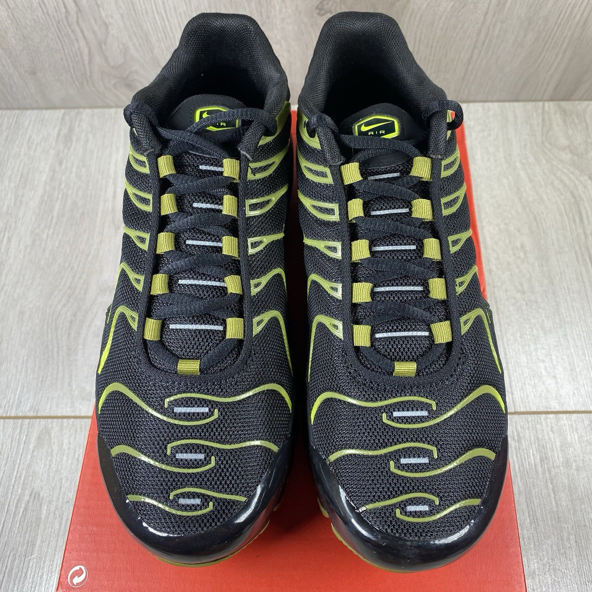 Nike Air Max Plus TN trainers black with cyber accents and mesh upper detailing.