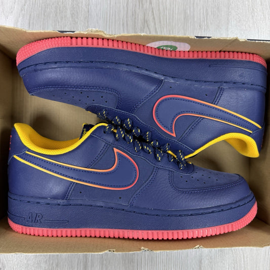Nike blue trainers with gold accents and retro design elements.
