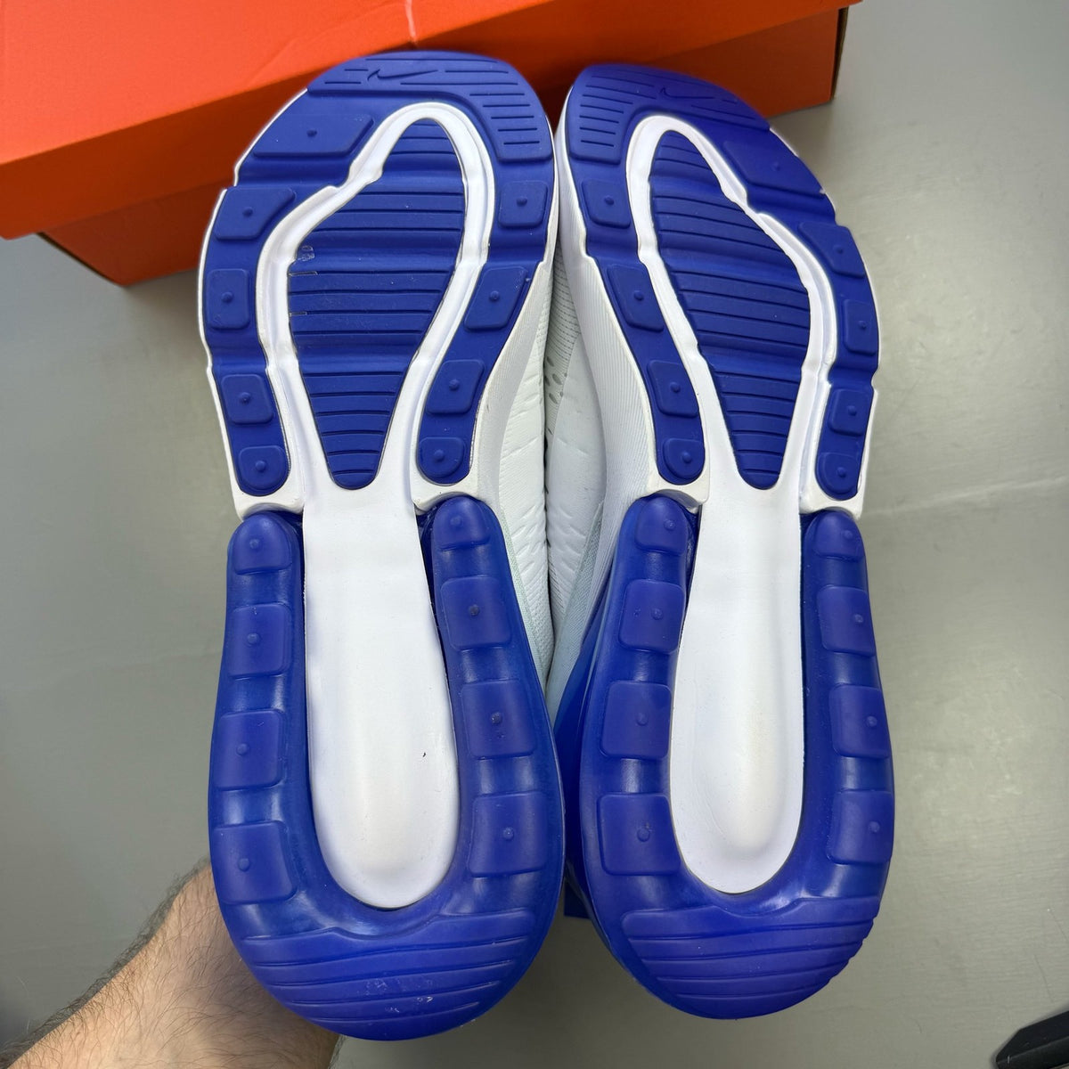 Nike Air Max 270 white trainers with racer blue accents and logo detail.