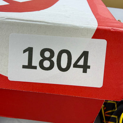Nike Air Max Plus TN black trainers with signature logo and vibrant sunrise detailing.