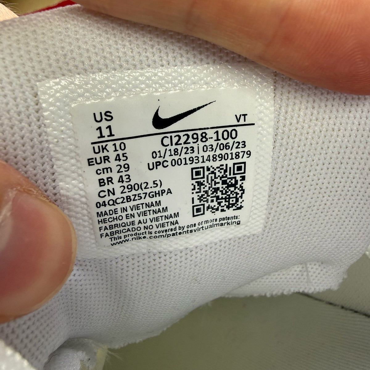Nike Air Max 95 white trainers with grey accents and signature swoosh logo.