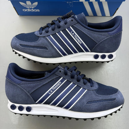 Adidas blue LA Trainer sneakers with white stripes and logo detailing.