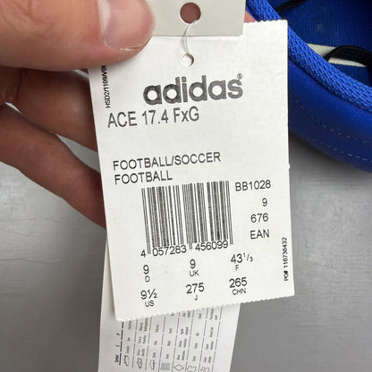 Adidas football boots white with blue and pink accents, featuring logo and textured material.