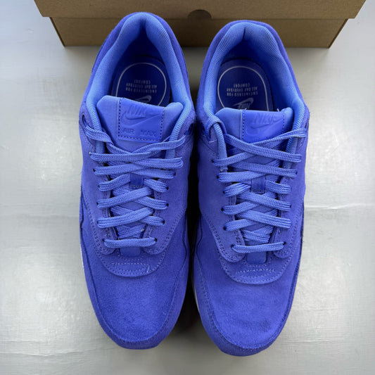 Nike Air Max 1 blue suede trainers with white accents and logo detail.