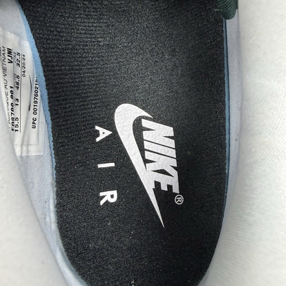 Nike Air Max 1 trainers green with white and silver accents, featuring iconic logo.