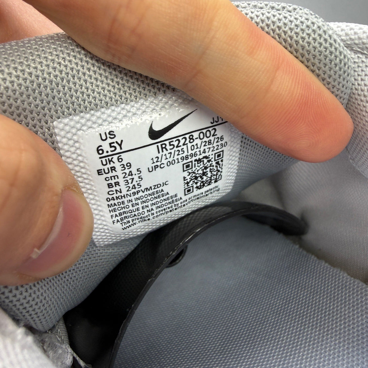 Nike deck shoes silver with logo details and sleek design.