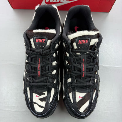 Nike black trainers zebra print design with solar red accents and white detailing.