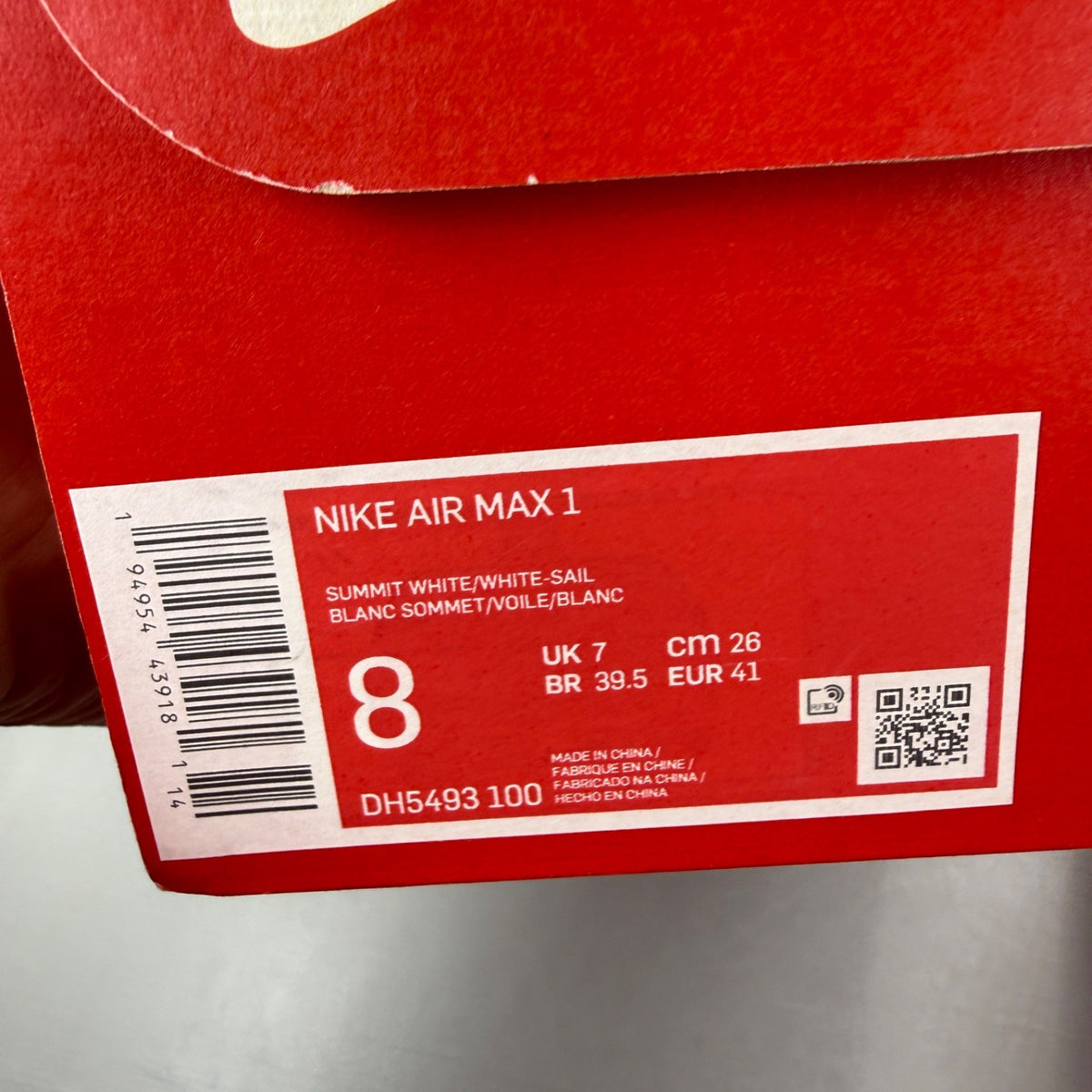 Nike Air Max 1 white trainers with rubberized details and classic logo design.