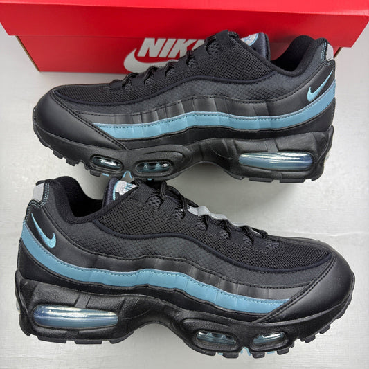 Nike running shoes black with smokey blue accents and visible Air Max cushioning.