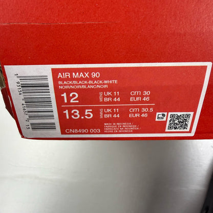 Nike Air Max 90 trainers black with logo detailing and sleek design.