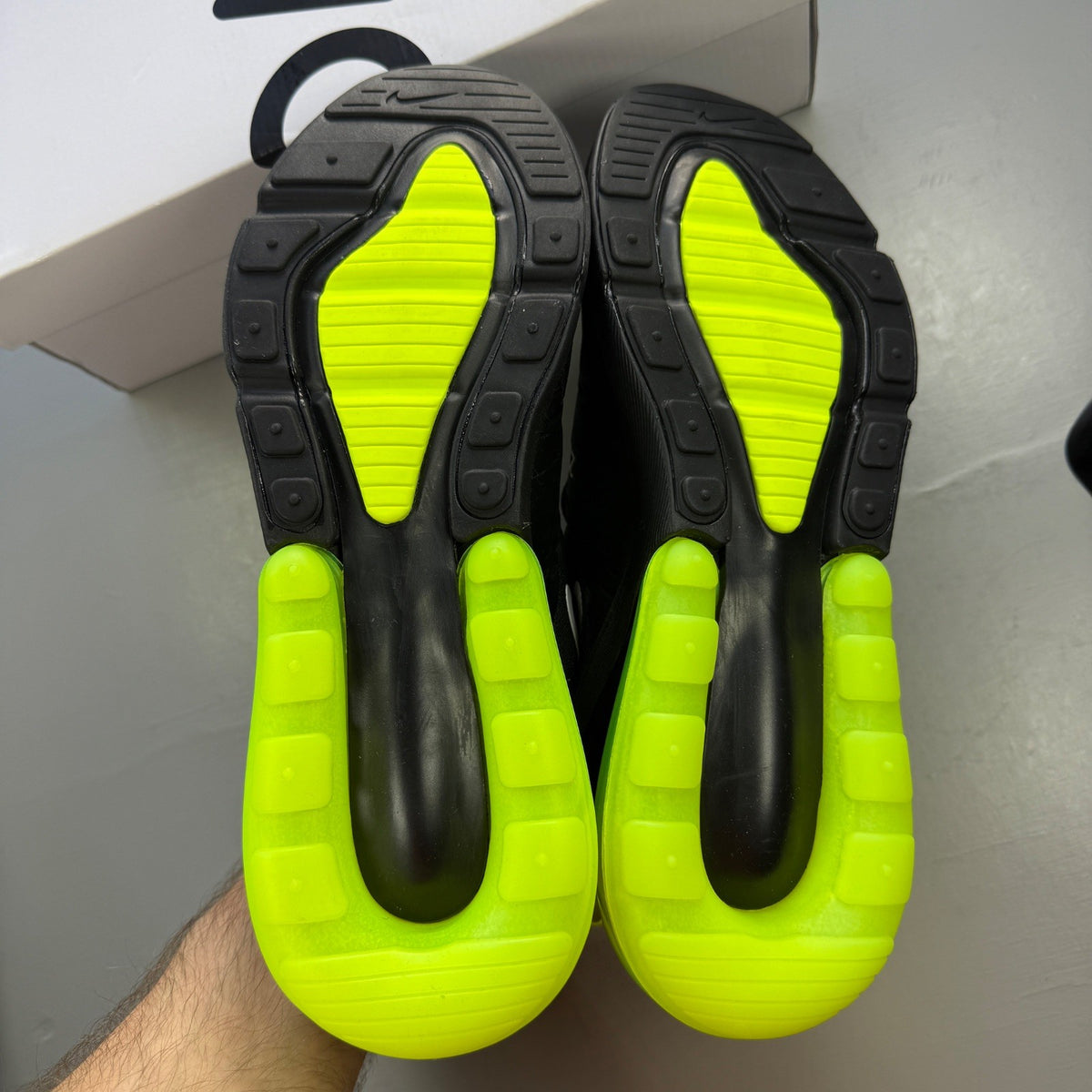 Nike Air Max 270 black trainers with neon volt green accents and white sole.