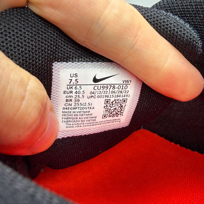 Nike trainers black with infrared accents and grey detailing, featuring Air Max cushioning.