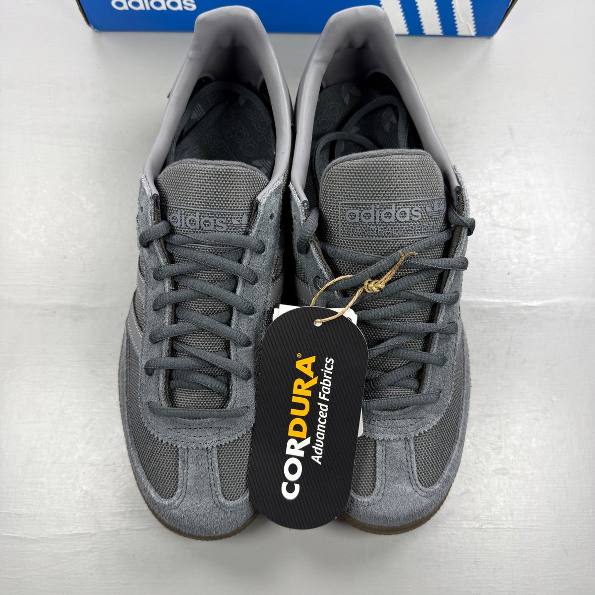 Adidas athletic shoes grey Cordura material with gum sole and logo detail.