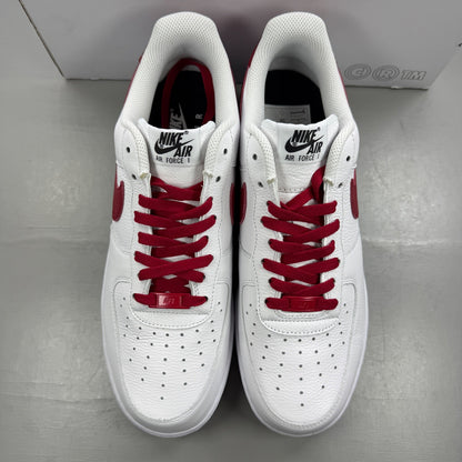 Nike deck shoes white leather with red accents and logo detail.