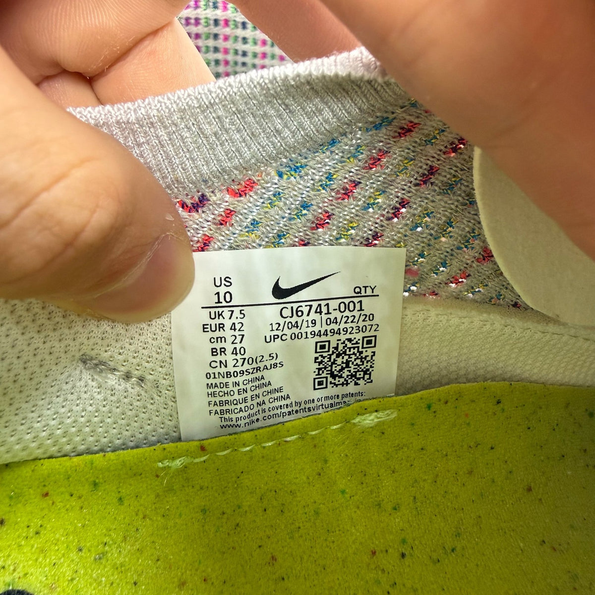 Nike multicolor Flyknit trainers in grey with distinctive air cushioning and logo detail.