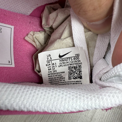 Nike white trainers with pink accents and gum sole, featuring iconic swoosh logo.