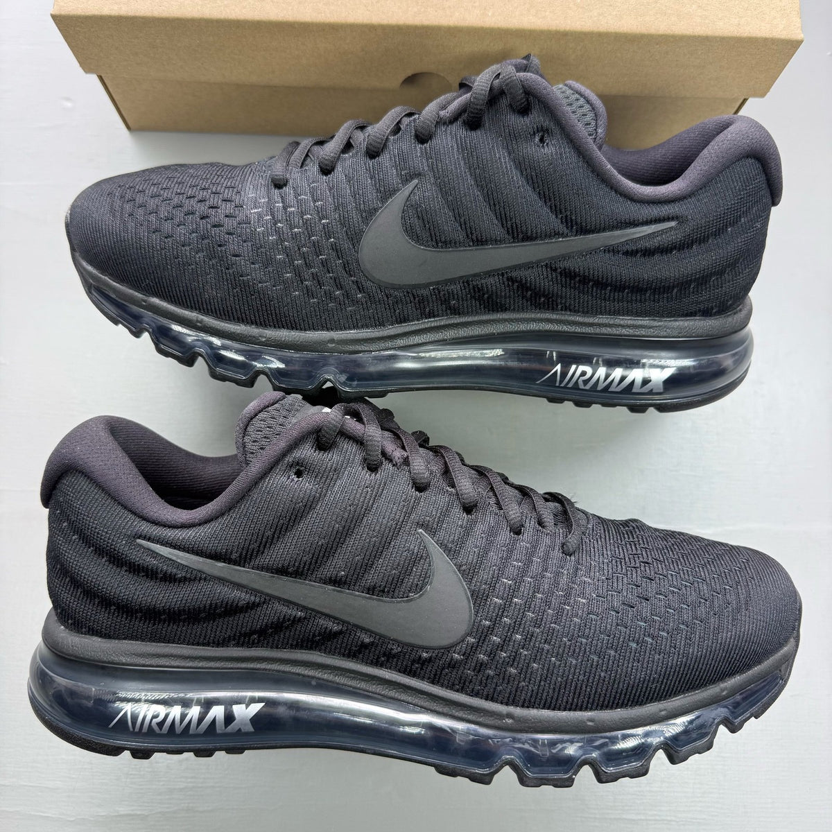 Nike Air Max 2017 black trainers with sleek design and logo detailing.