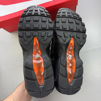 Nike Air Max 95 black grey trainers with safety orange accents and logo detailing.