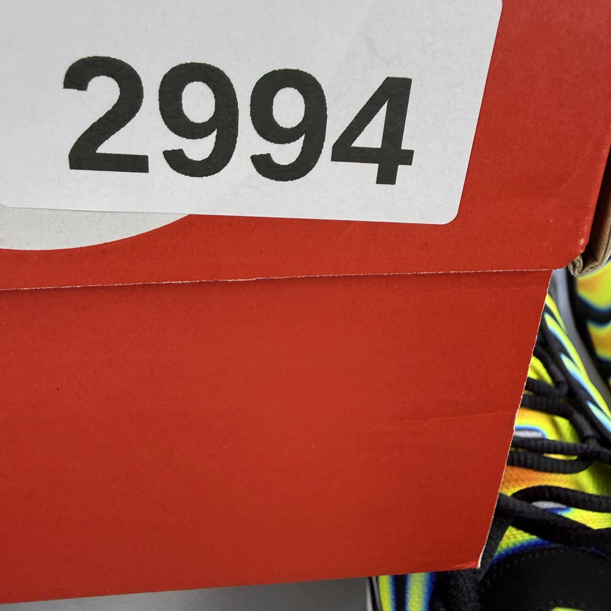 Nike trainers black with yellow heat map pattern and signature swoosh logo.