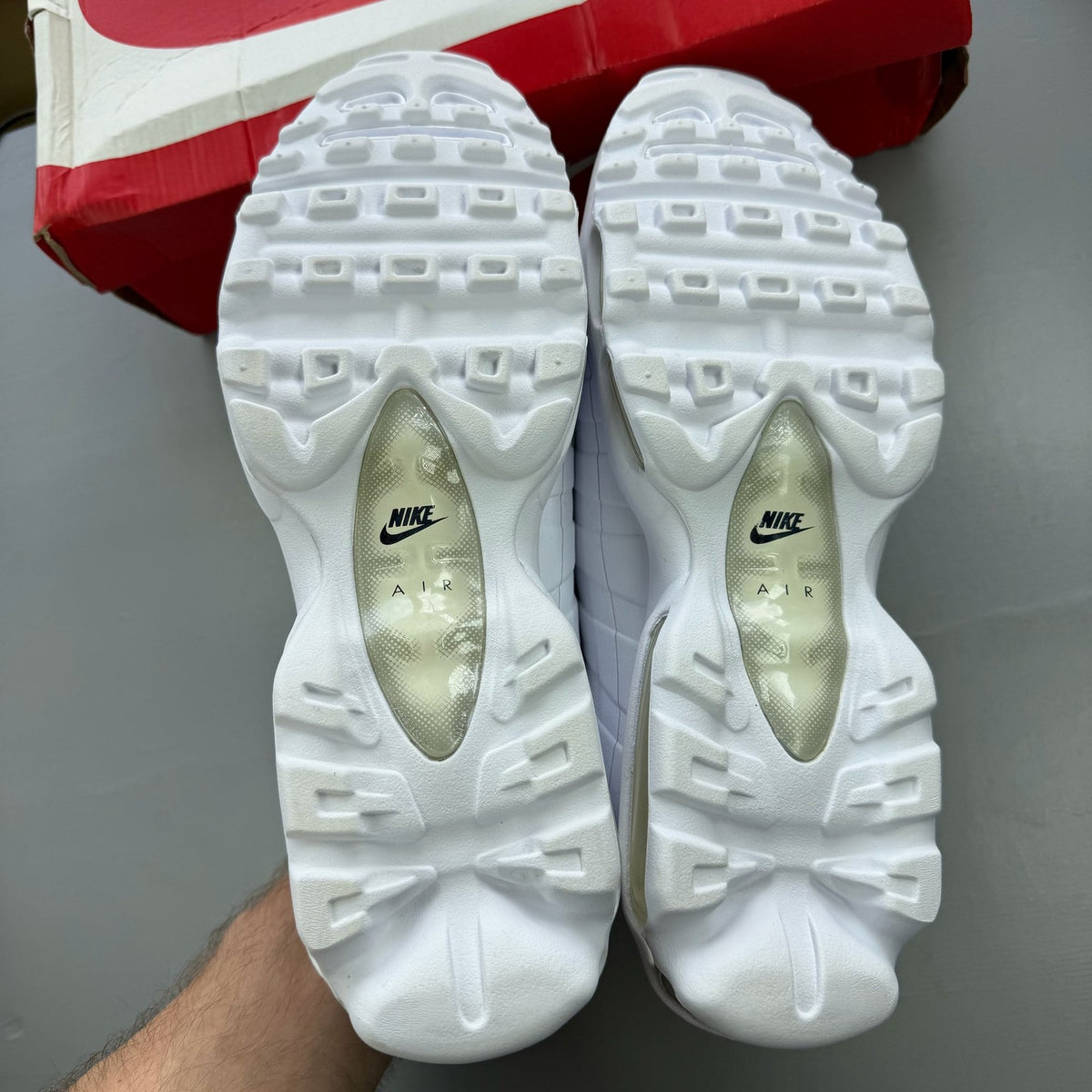 Nike Air Max 95 Ultra white trainers with reflective details and signature logo.