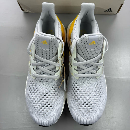 Adidas Ultra Boost 1.0 grey trainers with bold gold accents and white sole.