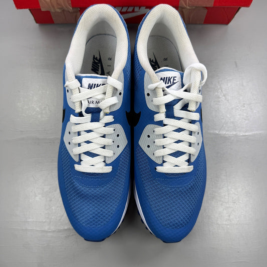 Nike Air Max 90 blue trainers with white accents and signature swoosh logo.