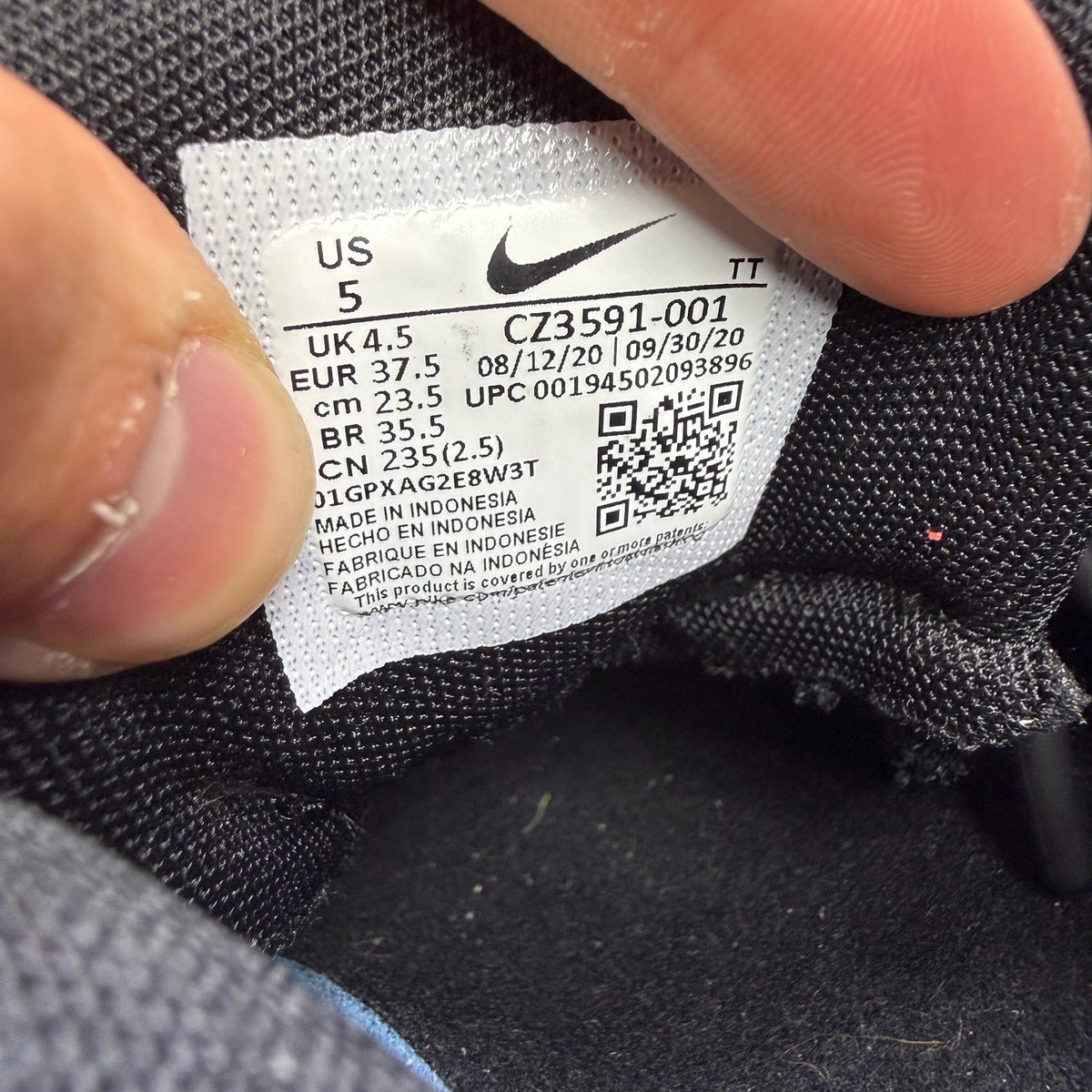 Nike Air Max 95 NDSTRKT black trainers with reflective detailing and logo accents.