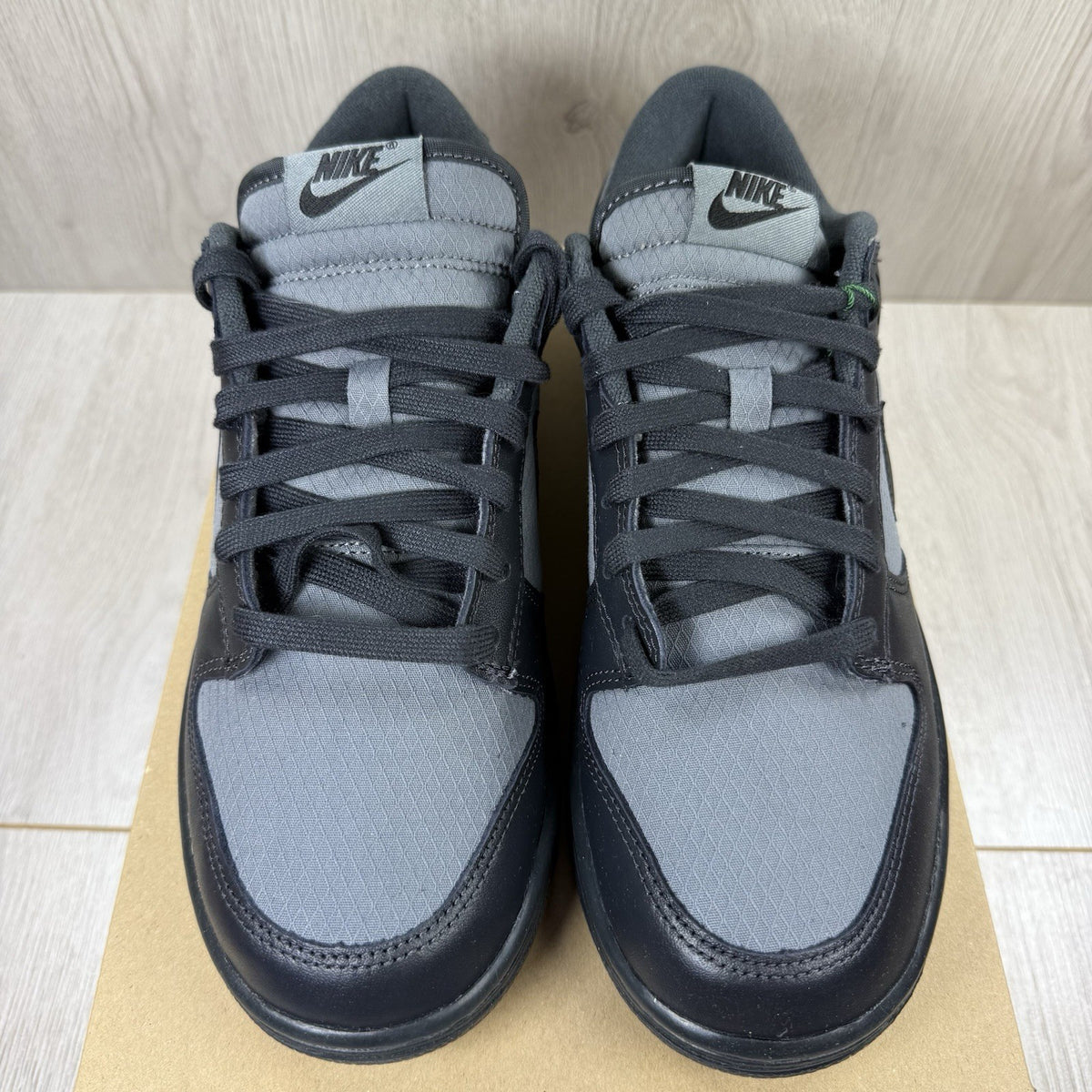 Nike Dunk Low Retro Off Noir grey trainers with black accents and signature swoosh logo.