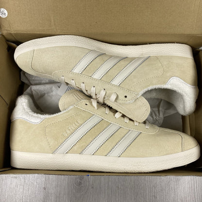 Adidas Gazelle trainers ecru tint with white stripes and suede upper material.