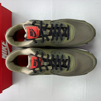 Nike Air Max 90 green trainers with black accents and classic logo detail.
