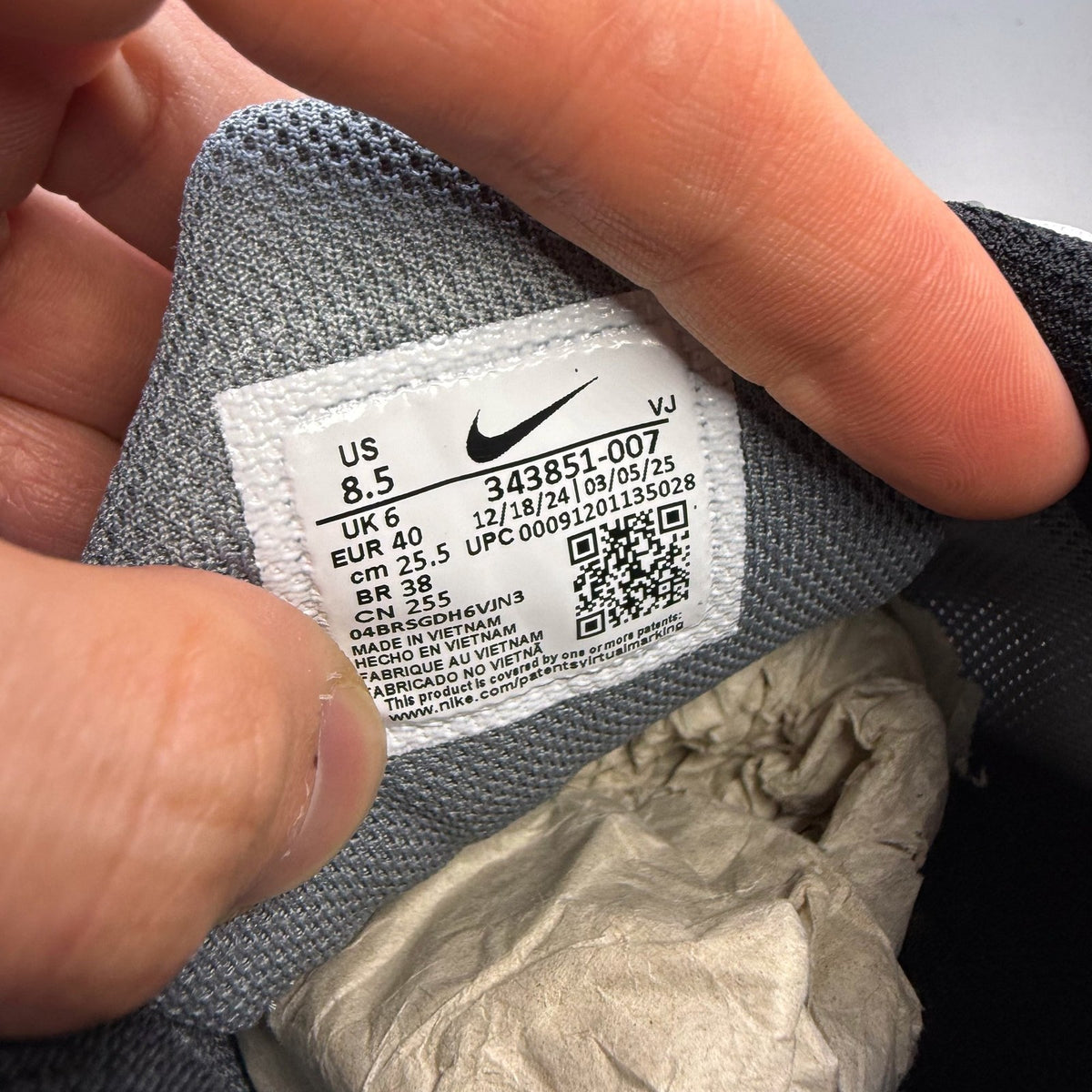 Nike Air Max Torch 4 grey and white trainers with mesh upper and signature swoosh logo.