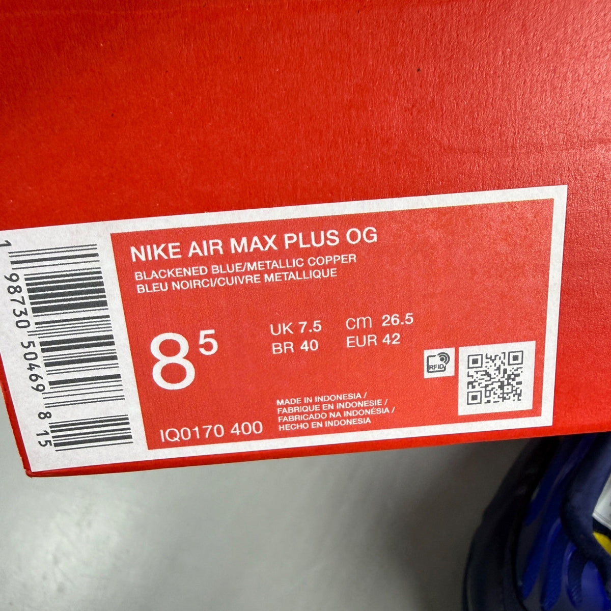 Nike running shoes metallic blue with copper accents and signature logo.