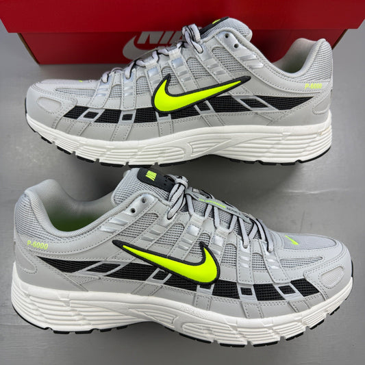 Nike athletic shoes grey with black and volt accents, mesh upper and logo detail.