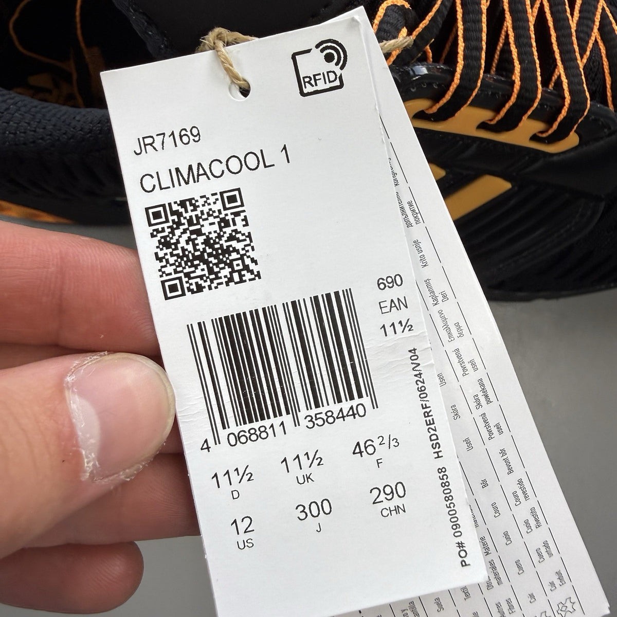 Adidas black trainers with flash orange accents and Climacool ventilation design.