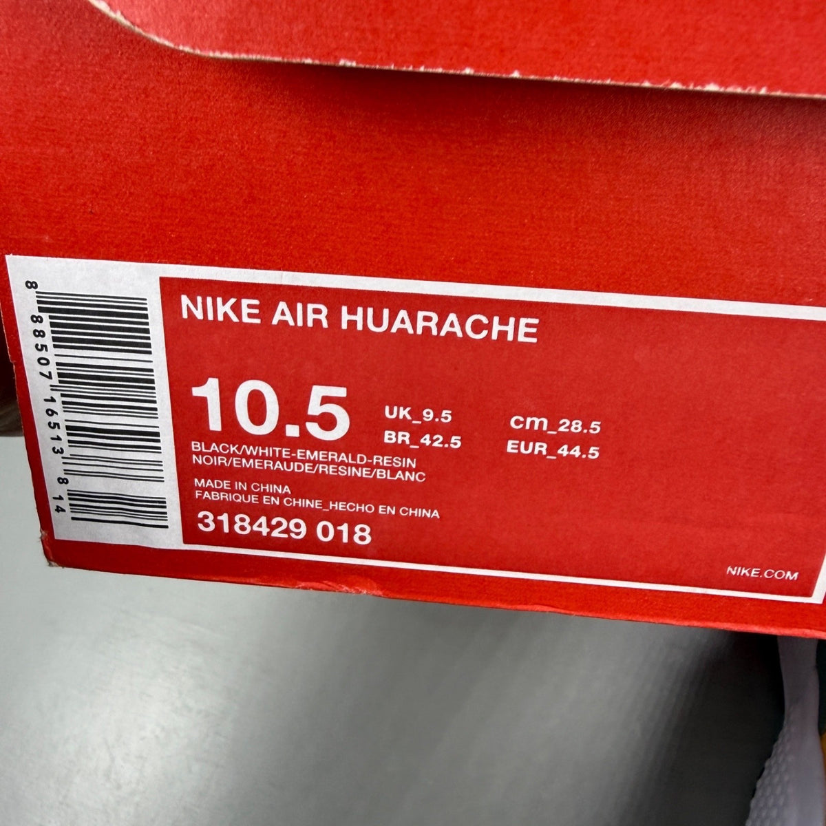 Nike athletic shoes black with emerald green accents and white sole, featuring iconic logo.