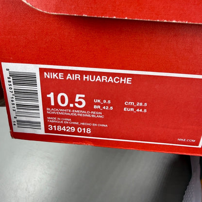 Nike athletic shoes black with emerald green accents and white sole, featuring iconic logo.
