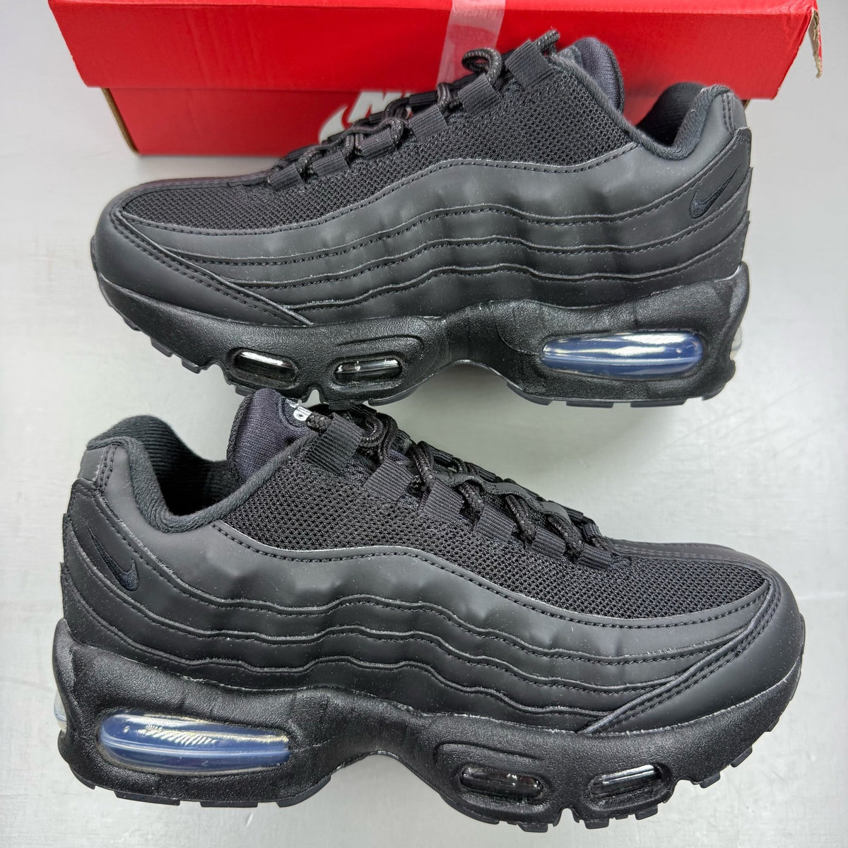Nike Air Max 95 black trainers with big bubble sole and logo detail.
