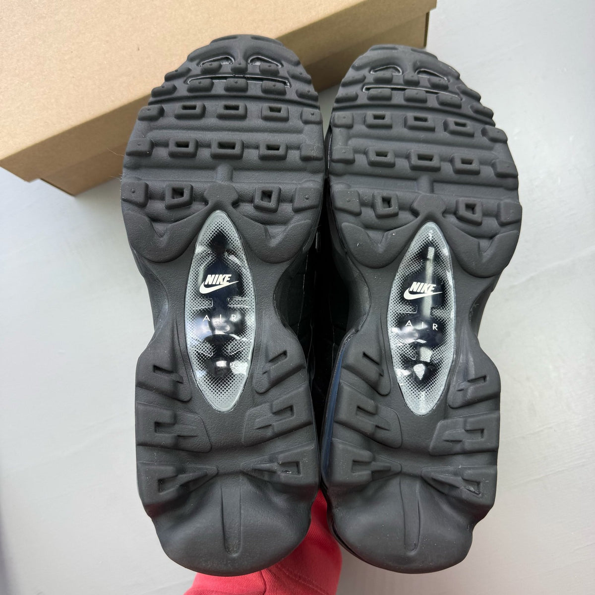 Nike black Air Max 95 trainers with reflective details and logo.