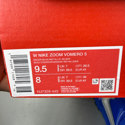 Nike Zoom Vomero 5 blue trainers with silver accents and logo detailing.