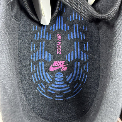 Nike black SB Zoom Stefan Janoski RM sneakers with white logo and sleek design.