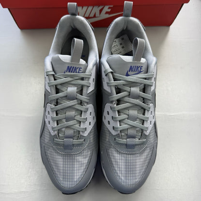 Nike Air Max 90 Drift grey trainers with deep royal blue accents and logo detail.