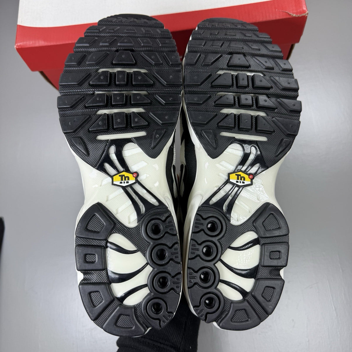 Nike Air Max Plus TN trainers white with black accents and signature logo details.