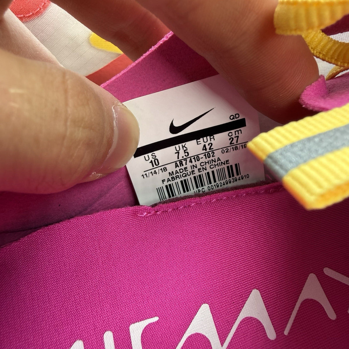 Nike Air Max Dia SE white trainers with laser fuchsia and gold accents, sleek design.
