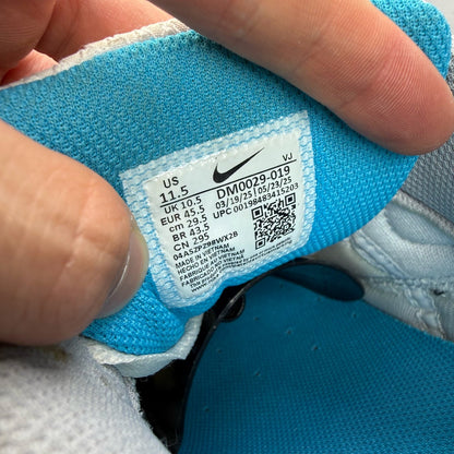Nike Air Max 90 grey trainers with blue accents and signature swoosh logo.