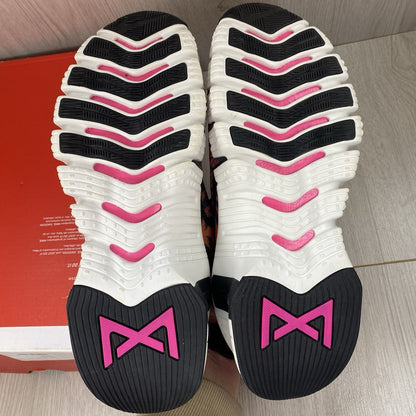 Nike Free Metcon 4 trainers black with tiger burnt sunrise accents and logo detail.