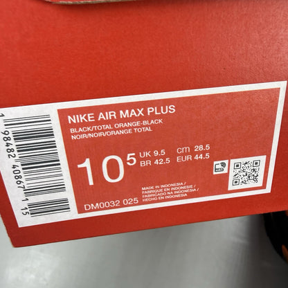 Nike Air Max Plus TN black trainers with total orange accents and signature logo.